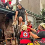 Tim penyelamat mengevakuasi warga dari rumah mereka yang terendam banjir setelah hujan deras yang dipicu Topan Kalmaegi di Provinsi Cebu, Filipina